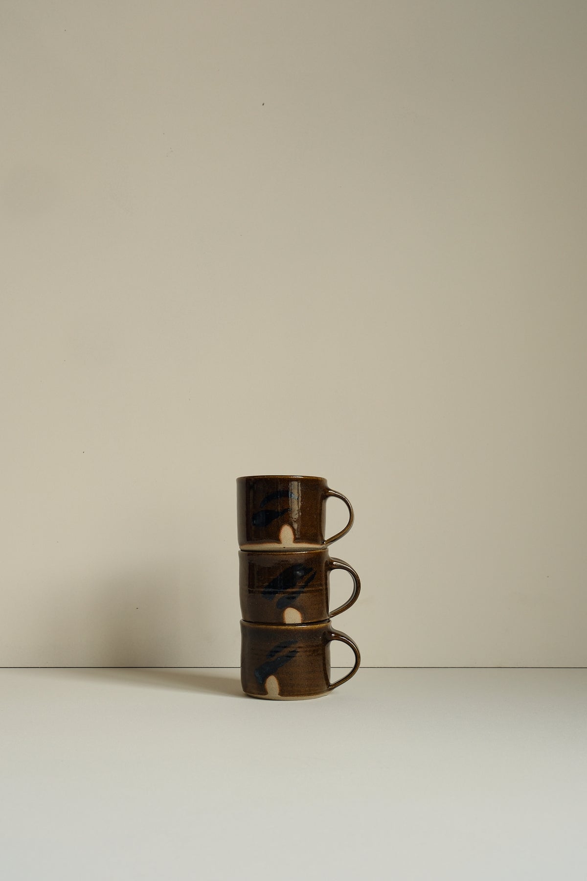 Abstract Umber Coffee Cup by Hannah Burgess
